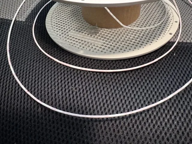 Custom printed filament wrapped back onto a spool